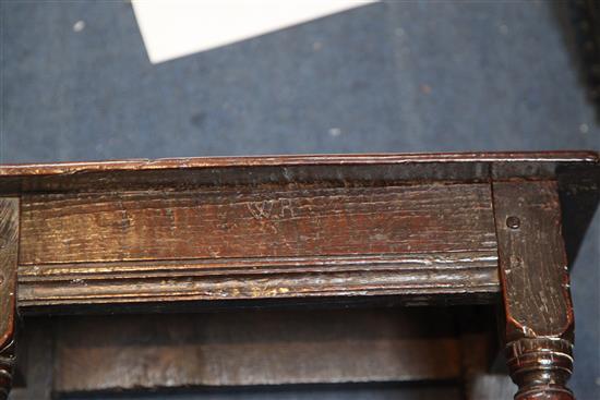 A 17th century oak joynt stool, incised with the initials W. R. 1ft. 7in. H.1ft 9in.